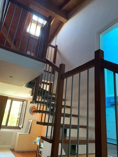 a spiral staircase in a house with a window at Appartamento Andrew’s house con parcheggio privato in Anzola dell'Emilia
