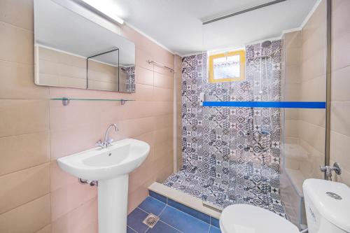 a bathroom with a sink and a shower at Happy Days in Malia