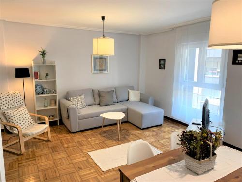 a living room with a couch and a table at Apartamento Parque - Playa San Lorenzo in Gijón