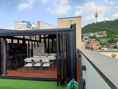 a balcony with a table and chairs on a building at 318 Stay in Seoul