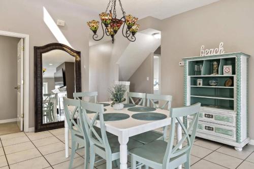 a dining room with a white table and chairs at Sea Forever Ocean Lookout | Flagler Beach in Flagler Beach