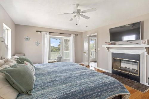 a bedroom with a large bed and a fireplace at Sea Forever Ocean Lookout Flagler Beach Ocean Views Pet Friendly in Flagler Beach