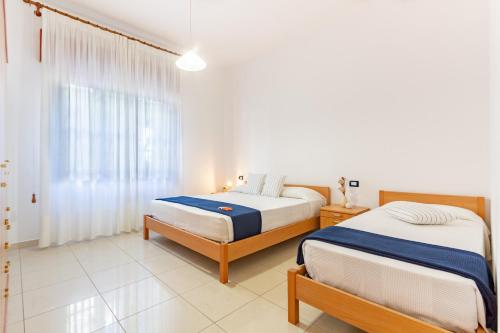 Ένα ή περισσότερα κρεβάτια σε δωμάτιο στο Appartamento Alba Rosa PT - MyHo Casa