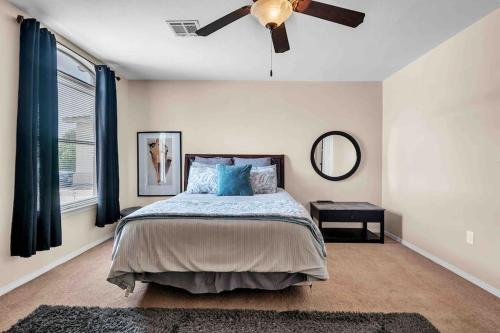 a bedroom with a bed and a ceiling fan at Comfy Classy Home, Close To Everything in El Paso