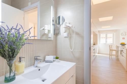 a bathroom with a sink and a mirror at Gia's Homes Cascais by LovelyStay in Cascais