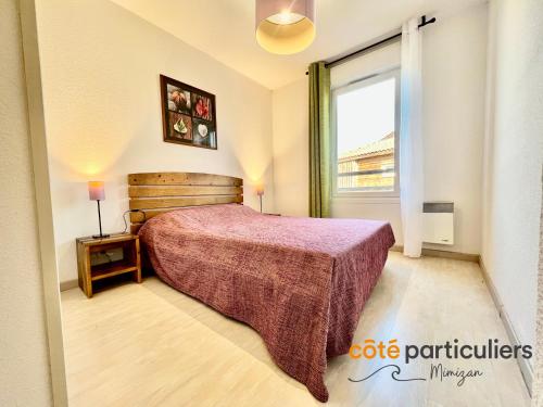 une chambre avec un lit et une grande fenêtre dans l'établissement LES TERRASSES DU LAC 26 - Apt T3 au bord du Lac, à Aureilhan