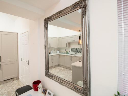 a large mirror on a wall in a kitchen at Pass the Keys Modern Coastal Cottage in North Shields