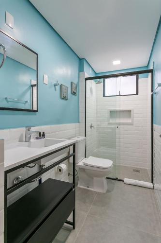 a bathroom with a toilet and a sink and a shower at Rooftop Pool | Balcony with Sea View #CA45 in Florianópolis