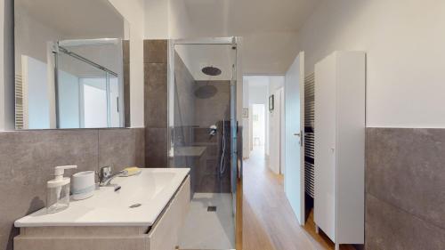 a bathroom with a sink and a mirror at Avantgard Rooms S. Orsola in Bologna