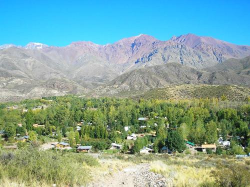 a small town in the middle of a mountain at Cabañas Troncos Del Salto in Potrerillos