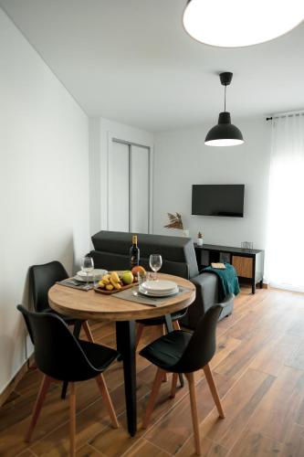 a living room with a table and chairs and a couch at Gold Apartment Ferrel I in Ferrel