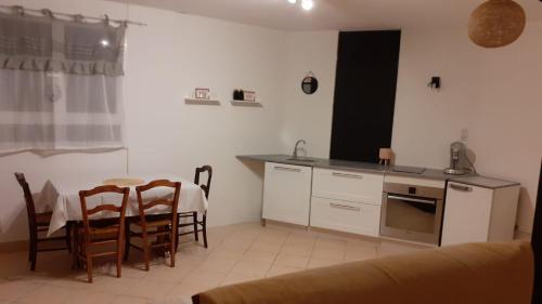 a kitchen and dining room with a table and chairs at Studio au cœur de Laguiole in Laguiole
