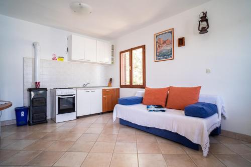 a living room with a bed and a kitchen at Sunny in Vela Luka