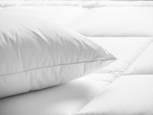 a white pillow sitting on top of a bed at Residence Inn Springfield in Springfield