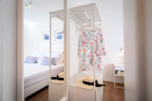 a bedroom with a bed and a dressing room with a mirror at Feelhvar along BlueLagoon beach in Hvar