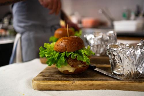 a sandwich on a cutting board on a table at Hotel Du Lac in Molveno