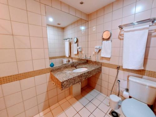 a bathroom with a sink and a toilet at Flat Hotel Nobile A18 in Brasilia
