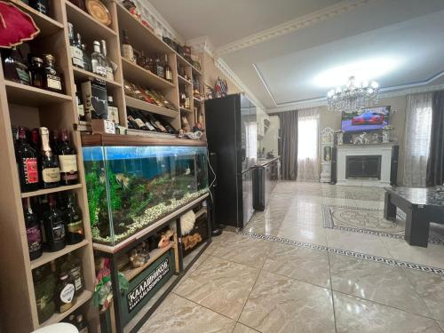 a large room with a fish tank on a shelf at Guest House Nice in Tbilisi City