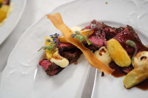 a white plate with some food on it at Hotel Du Lac in Molveno