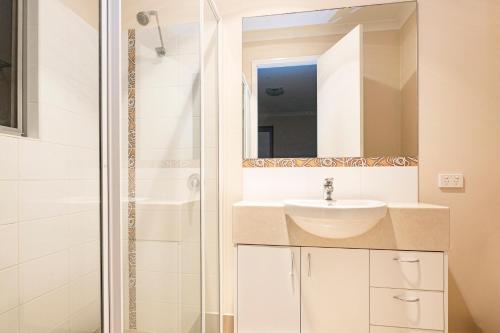 a bathroom with a sink and a shower at Whatmans Beach House - on the water's edge in Dunsborough