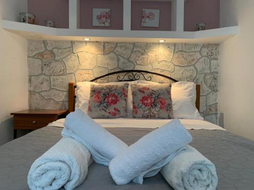 a bedroom with a bed with towels on it at Kastro Studios in Skopelos Town
