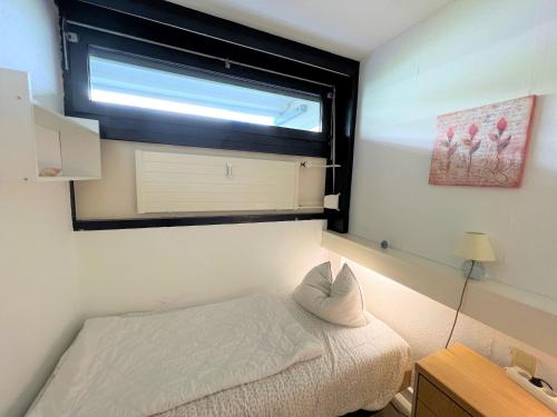 - une petite chambre avec un lit et une fenêtre dans l'établissement Ferienpark Sierksdorf App 53 - Strandlage, à Sierksdorf