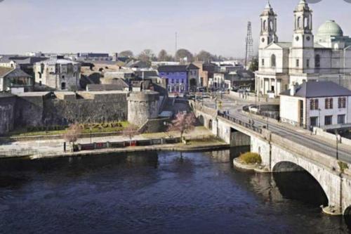 a bridge over a river next to a city at Private bedroom. Athlone and Roscommon nearby in Roscommon