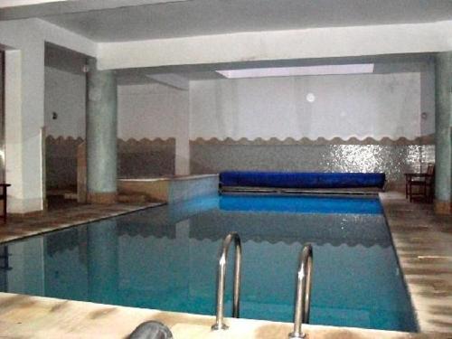 a swimming pool with blue water in a building at Luxury Appartement in Marrakesh