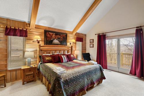 a bedroom with a bed and a desk and a window at Altitude Adjustment in Blowing Rock