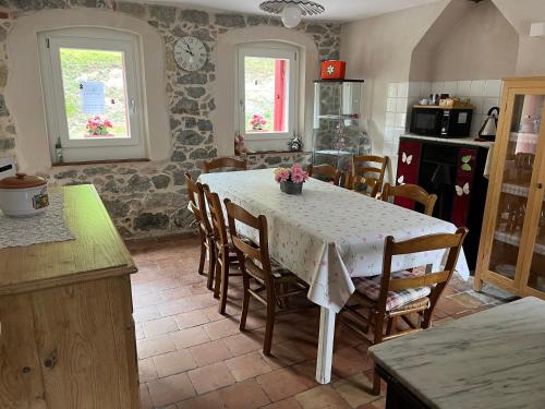 a kitchen with a table and chairs in a room at ALTRAVISTA TARZO in Revine Lago