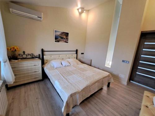 a bedroom with a bed and a dresser at Naykova district Apartments in Kharkiv