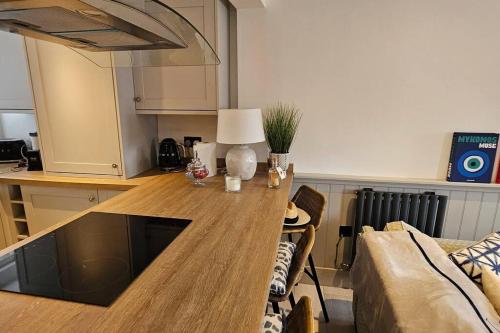 a kitchen with a wooden table in a living room at Humberston Boathouse Lodge & Hot Tub - Cleethorpes Beach Cabin Chalet in Humberston