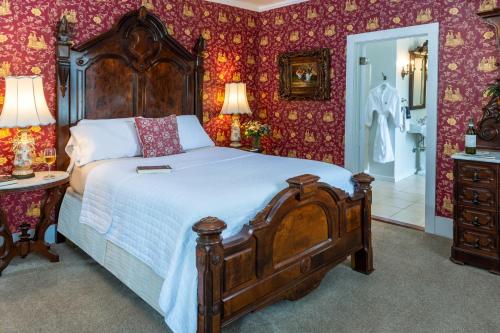 a bedroom with a large bed and a bathroom at Amelia Island Williams House in Fernandina Beach