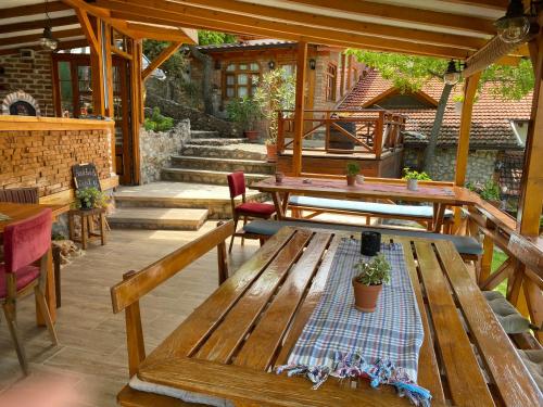 an outdoor patio with wooden benches and tables at Paradise Nest in Ohrid