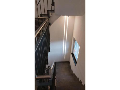 a stairwell in a building with stairs and a television at Privatzimmer Sulzberger in Freiamt