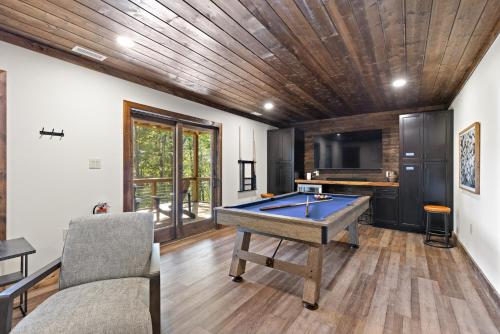 a living room with a pool table and a tv at Angels Share in Seven Devils