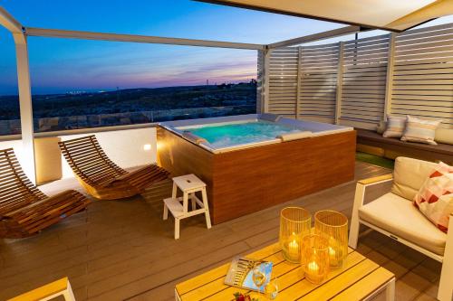 a hot tub on the balcony of a building at Melifra, Jacuzzi e Vista Panoramica in Ispica