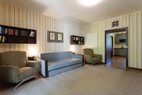 a living room with a couch and two chairs at Naykova district Apartments in Kharkiv