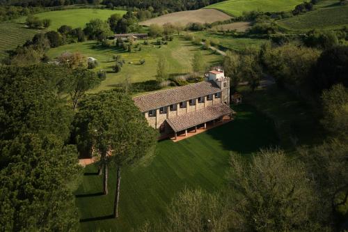 an aerial view of a house in a field at UNA Hotels Monterufoli Wine Country in Monteverdi Marittimo