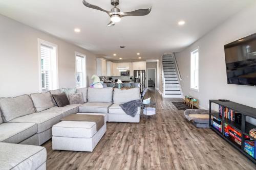 a living room with a white couch and a tv at Cora's Beach Club in Seaside Heights