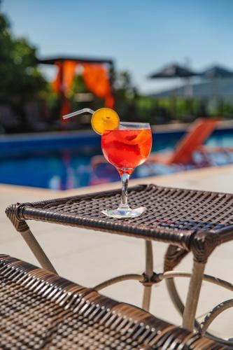 a drink sitting on a table next to a pool at Slaviero Ingleses Convention in Florianópolis