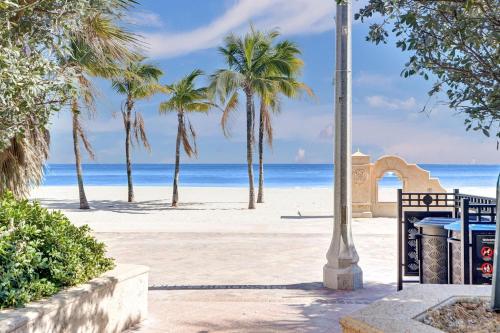 a beach with palm trees and a light pole at Hollywood Apartments Host by BeeNomad in Hollywood