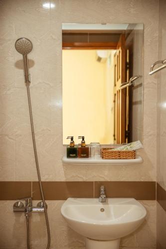 a bathroom with a toilet and a sink and a mirror at Thùy Trang Hotel in Vung Tau