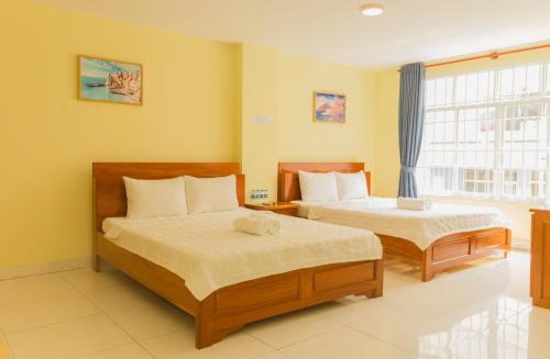 Ένα ή περισσότερα κρεβάτια σε δωμάτιο στο Thùy Trang Hotel