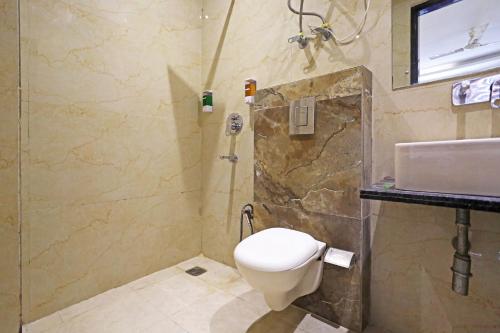a bathroom with a toilet and a sink at HOTEL ICONIC At Delhi International Airport in New Delhi