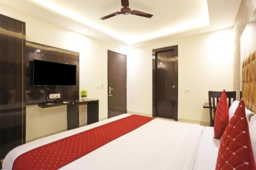 a bedroom with a bed and a flat screen tv at HOTEL ICONIC At Delhi International Airport in New Delhi