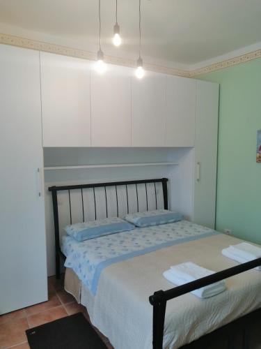 a bedroom with a bed and white cabinets at SPELLO ROMANTICA in Spello