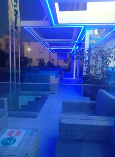 a room with blue lights and benches in a building at Sunny Blue Hotel in Ayia Napa