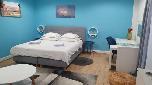 um quarto com uma cama com uma parede azul em Holiday home Blue door in Pula em Pula