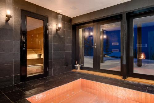 a bathroom with a bath tub with windows at Stora Björnrike in Vemdalen